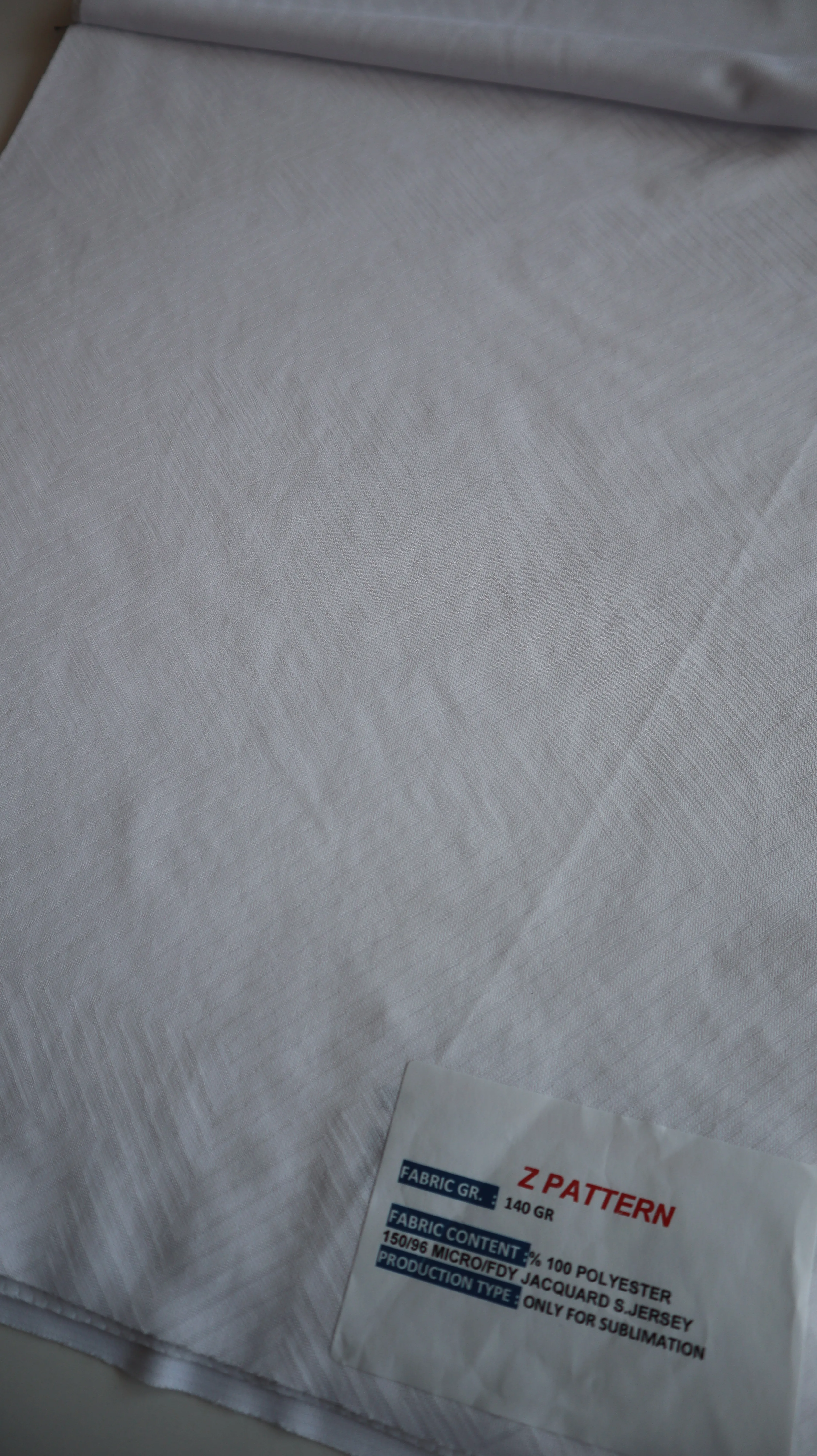 Performance sportswear fabric construction close-up showing knit surface and stretch