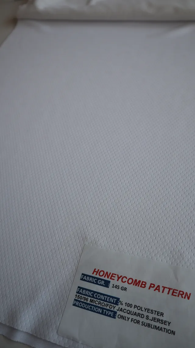 Performance sportswear fabric construction close-up showing knit surface and stretch — 7