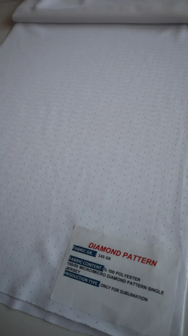 Performance sportswear fabric construction close-up showing knit surface and stretch — 8
